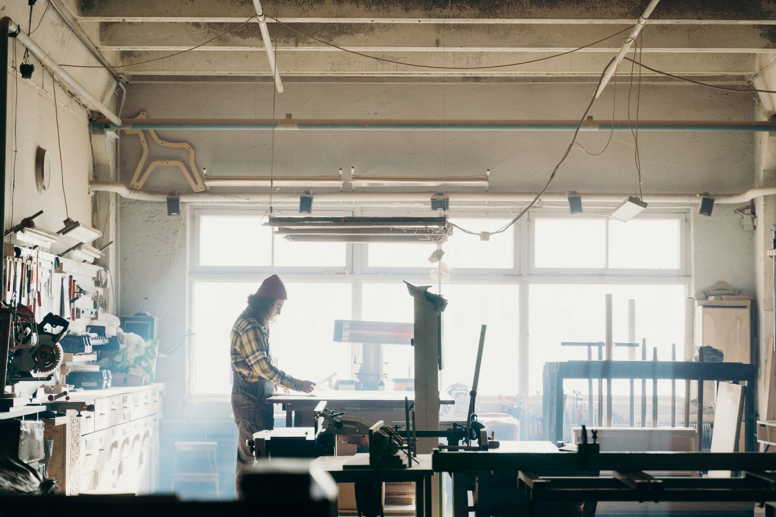 Woodworker in sunlit workshop